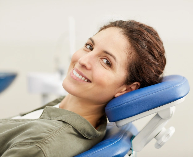 Smiling woman relaxing in dental chair at modern dentist office