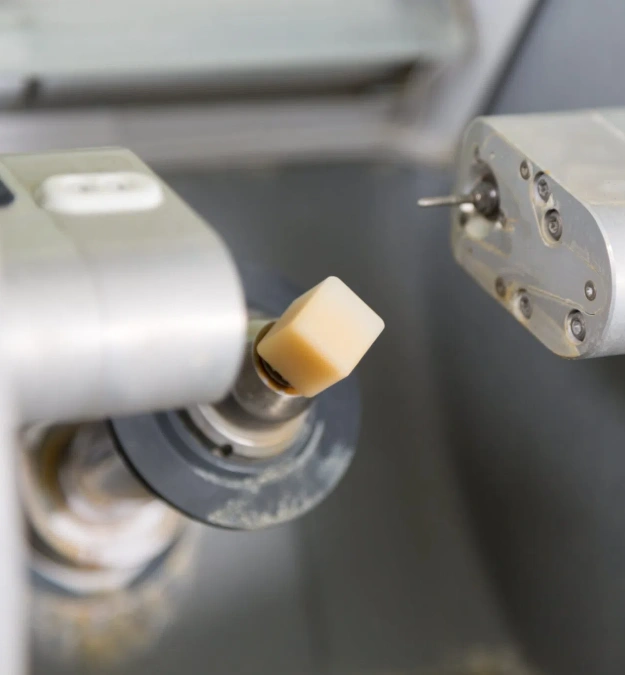 Dental handpiece with brass coupling attached to tubing in clinical operatory setting