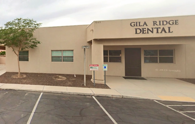 Gila Ridge Dental exterior building with entrance, parking lot, and desert landscaping.