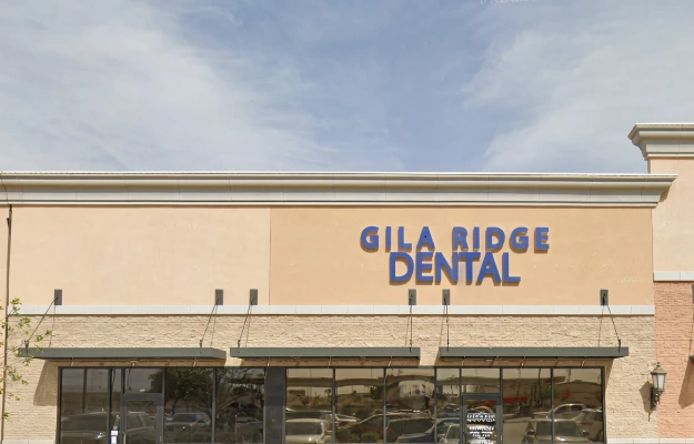 Gila Ridge Dental storefront exterior with blue signage on beige building facade.